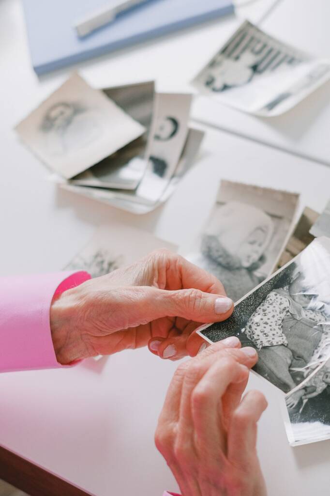 Hands holding old black-and-white photographs