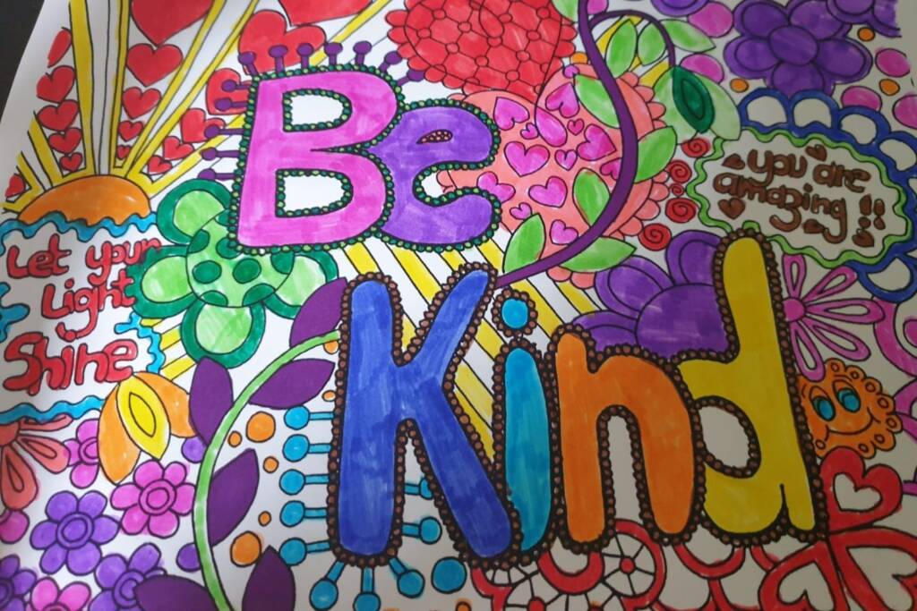 A brightly coloured-in poster that reads “Be Kind”, “Let your light shine” and “You are amazing”